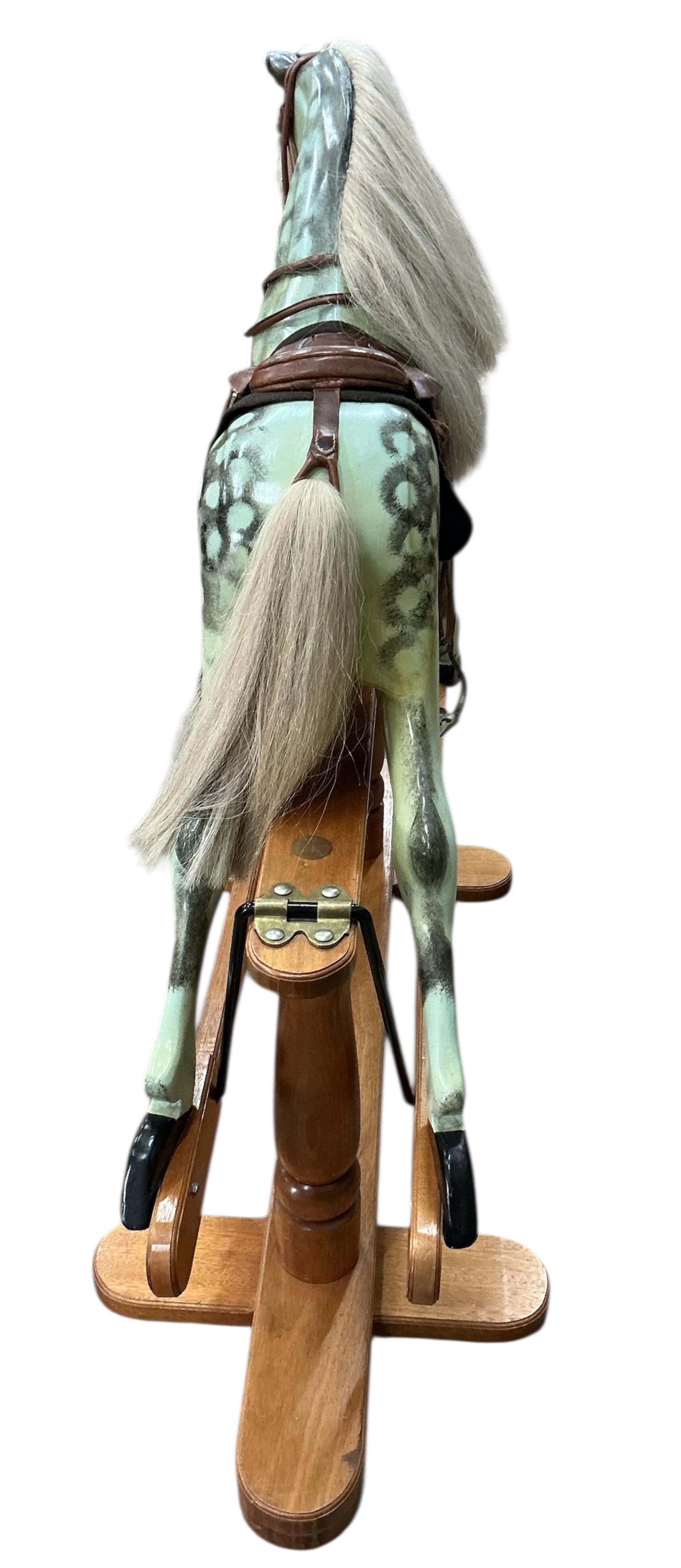 A modern Robert Mullis of Swindon dapple grey rocking horse with tan leather tack on mahogany safety frame, height 116cm
